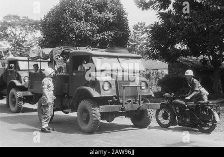 [Military policeman checks documents of an army truck] Date: 01/01/1947 Location: Indonesia Dutch East Indies Stock Photo