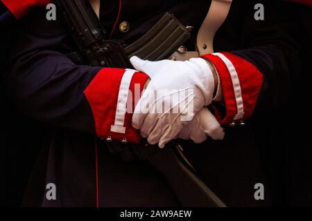 Close up of a Sardinian Grenadier cradling automatic weapon in full uniform gloved hands Stock Photo