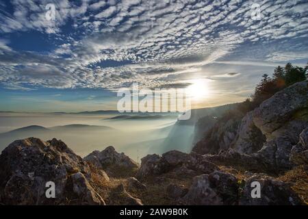 Sunset over the clouds in the mountains Stock Photo