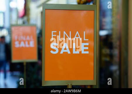 Premium Photo  Sale in the women's section of a clothing store. red sign  with the inscription sale, discount in the shop, blurred background. black  friday, sale concept