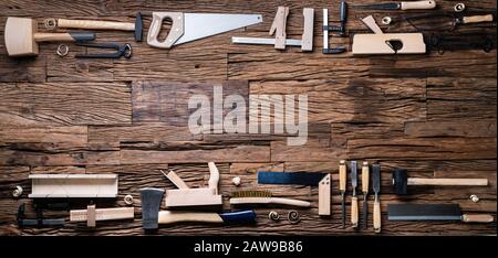 Various Carpenter Tools From Toolkit Laying On Desk Stock Photo