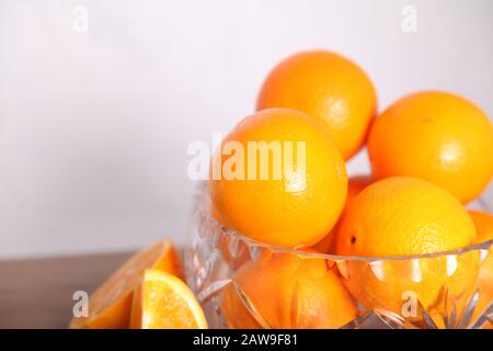 Lead crystal fruit bowl full of oranges 'fruit' against white background with copy space Stock Photo