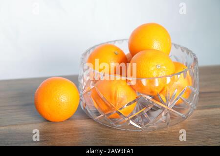 Lead crystal fruit bowl full of oranges 'fruit' against white background Stock Photo