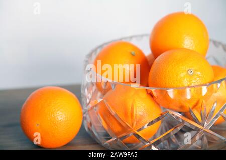 Lead crystal fruit bowl full of oranges 'fruit' against white background Stock Photo