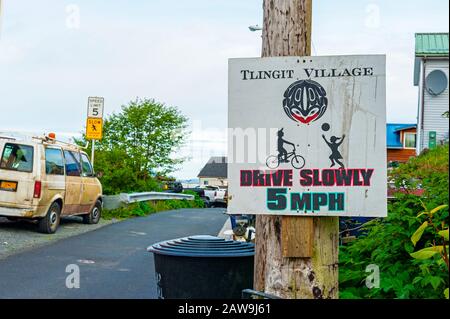 Street scene and Drive Slowly sign on Kaagwaantaan street in Sitka, Alaska, USA Stock Photo