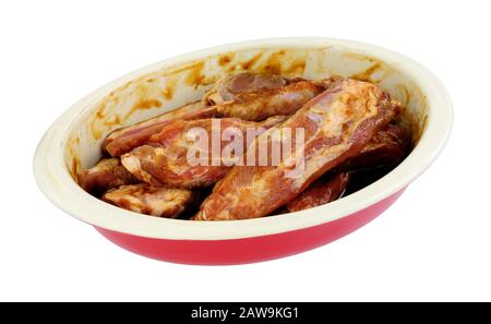 Group of fresh raw pork ribs marinating in a dish isolated on a white background Stock Photo