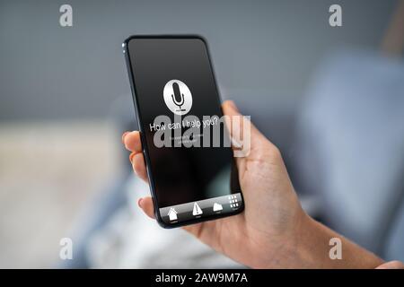 Person Using Voice Recognition Function On Mobile Phone Stock Photo