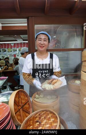 Woman, 52, does Mandu, Insadong district, Seoul, South Korea Stock Photo