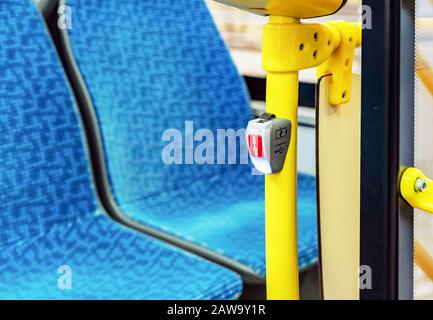 Red stop button in public transport. Bus stop button at the request of the passenger. Stock Photo
