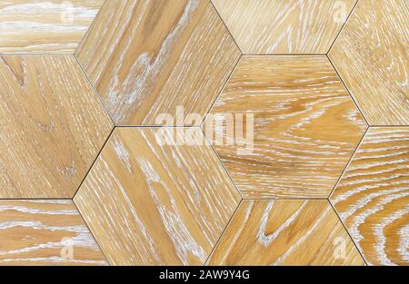 Ceramic tiles in the form of honeycombs with wood texture. Beige hexagonal floor tiles. Stock Photo