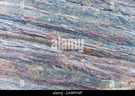 Texture of natural stone with blue and orange stripes. Grunge background. Stock Photo