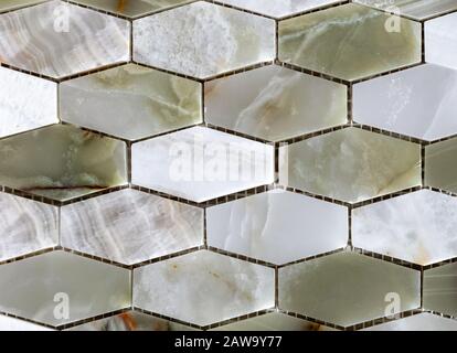 Tile mosaic of green and white natural onyx. Quartz stone tile. Stock Photo