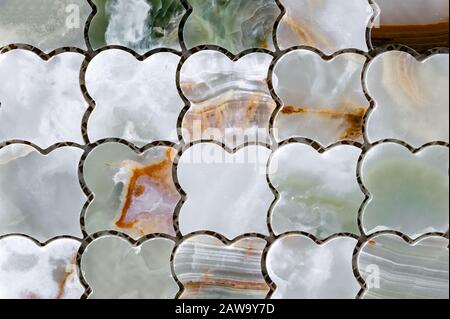 Tile mosaic of green and white natural onyx. Quartz stone tile. Stock Photo