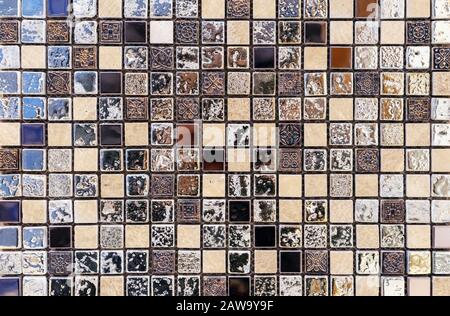 Ceramic mosaic tile in antique style with beige, black and blue squares. Stock Photo