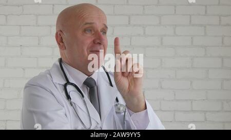 Confident Doctor Smiling and Warning Pointing with Finger Making Attention Sign with a Hand Gestures Stock Photo