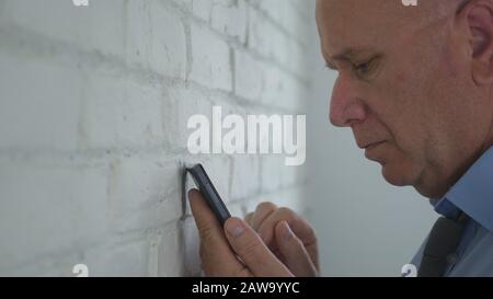 Image with a Disappointed Businessman Using a Cellphone Stock Photo