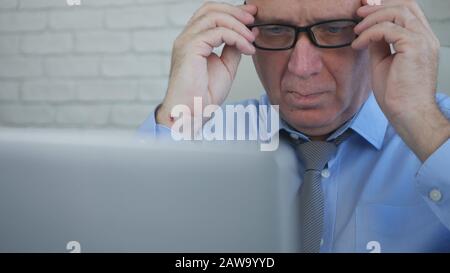 Serious Businessman in Office Room Using a Laptop, Businessperson Managing Company Information Stock Photo