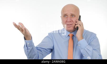 Disappointed Businessman Talk about Bad News on Cellphone and Make Nervous Hand Gestures Stock Photo