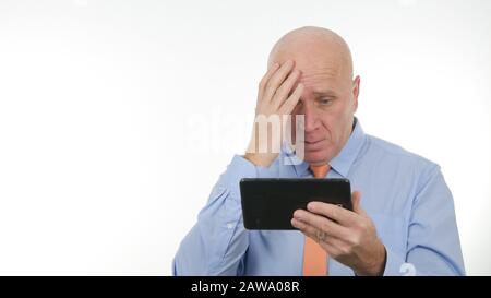Businessman Gesturing Nervous and Unhappy After Reading a Bad Message on Tablet Stock Photo