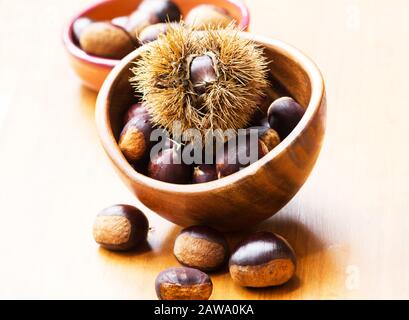 Chestnuts on a wooden bowl Stock Photo