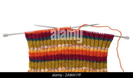 Knitting pattern on needles of woolen threads colorful isolated on white background. Stock Photo
