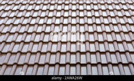 Tile roof background and texture. Pattern of the wet tiles roof of house. Roof tiles covered with water. Stock Photo