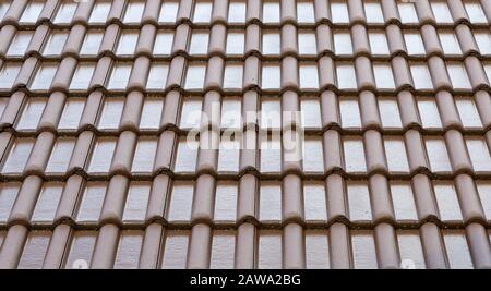 Tile roof background and texture. Pattern of the wet tiles roof of house. Roof tiles covered with water. Stock Photo