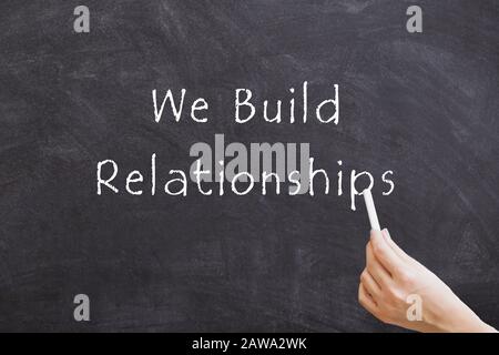 We Build Relationships on blackboard Stock Photo