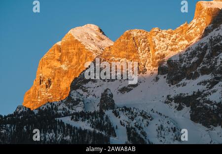 Tofana di Rozes or Tofana I Peak in Cortina d'Ampezzo in Winter at Dawn, Snow Covered at Sunrise with Early Morning Light with Ski Slopes Stock Photo