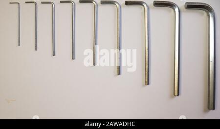 Hexagonal key on a white background. Copy space. Stock Photo
