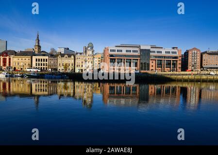 Newcastle Crown Court built out of red sandstone stands out on the Quayside on the north side of the River Tyne Stock Photo