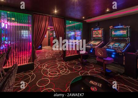 LAS VEGAS, USA - MAY, 2017: interior of elite luxury vip casino with rows of gambling slots machine in cherry red color style Stock Photo