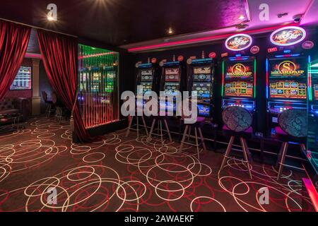 LAS VEGAS, USA - MAY, 2017: interior of elite luxury vip casino with rows of gambling slots machine in cherry red color style Stock Photo