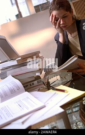 Business woman with a headache stressed and overwhelmed by work Stock Photo