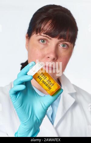 Young Caucasian female scientist holds medication pills inhibitor of novel 2019-nCoV coronavirus infection that is currently tested on patients in Chi