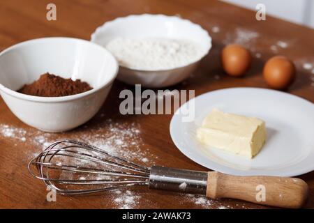The ingredients needed for preparing homemade chocolate cupcakes Stock Photo