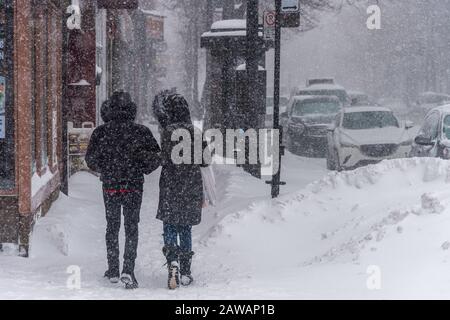Montreal, CA - 7 February 2020: Pedestrians walking on Saint Laurent Boulevard during snow storm. Stock Photo