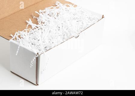 A close-up studio shot of a generic open white packaging box set on a plain white background. Stock Photo