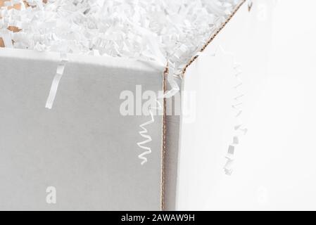 A close-up studio shot of a generic open white packaging box set on a plain white background. Stock Photo