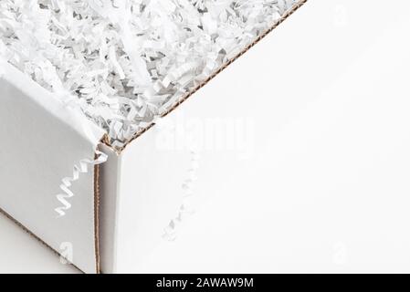 A close-up studio shot of a generic open white packaging box set on a plain white background. Stock Photo