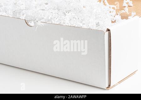 A close-up studio shot of a generic open white packaging box set on a plain white background. Stock Photo