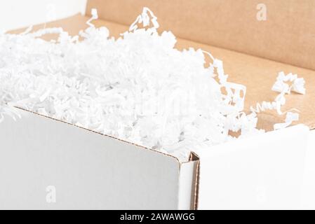 A close-up studio shot of a generic open white packaging box set on a plain white background. Stock Photo
