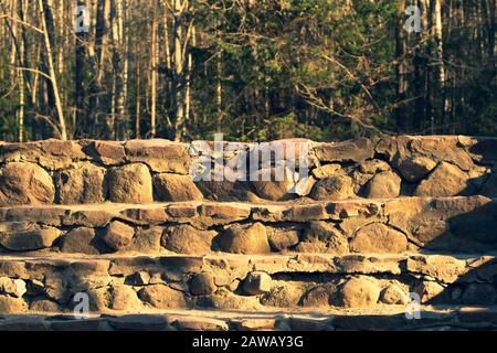 Stone steps ladder. stairs from natural stones in the park background Stock Photo