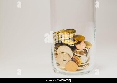 Glass jar with international coins from various countries. finance storage concept. copy space Stock Photo