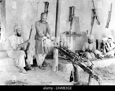 Photograph taken in 1930 by ERNEST B. SCHOEDSACK of ALFRIDI TRIBESMEN at work in a Native Rifle Factory in Independent Tribal Territory at KOHAT PASS INDIA taken on expedition to film Location Footage for proposed movie from the book THE LIVES OF A BENGAL LANCER by Francis Yeats Brown Paramount Pictures Stock Photo