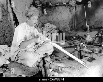 Photograph taken in 1930 by ERNEST B. SCHOEDSACK of an ALFRIDI TRIBESMAN at work in a Native Rifle Factory in Independent Tribal Territory at KOHAT PASS INDIA taken on expedition to film Location Footage for proposed movie from the book THE LIVES OF A BENGAL LANCER by Francis Yeats Brown Paramount Pictures Stock Photo