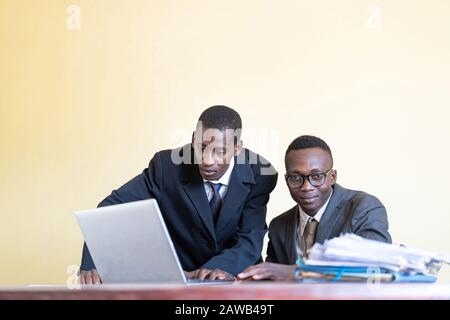 Photograph of working men at work celebrating at the workplace Stock Photo