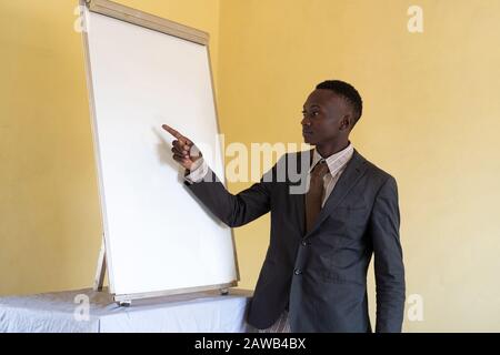 African ethnicity brave person brainstorming worker feeling confident in front of whiteboard Stock Photo