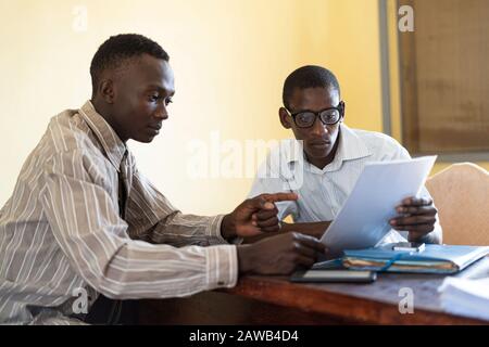 Black African ethnicity people working together on documents in the studio or office Stock Photo