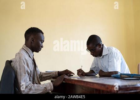 African American business coworkers people working together on assignment job signing Stock Photo